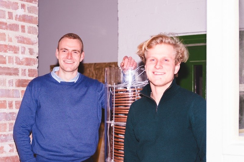 Felix Drechsel and Jeremias Polster next to a prototype of a wastewater heat exchanger